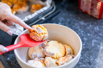 Woman cooking delicious syrniki in the kitchen, close-up.