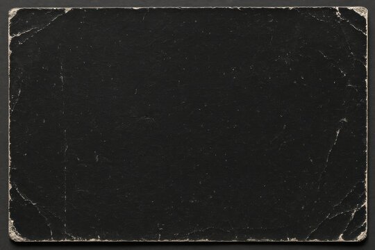 Vintage aged scratched black paper texture with torn corners. Abstract background, design overlay.