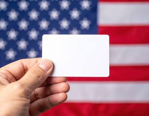 Obraz premium Hand holding blank card against american flag background