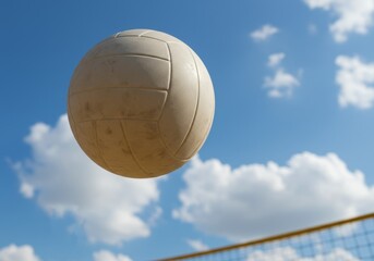 Volleyball Flying High Against Blue Sky and Clouds