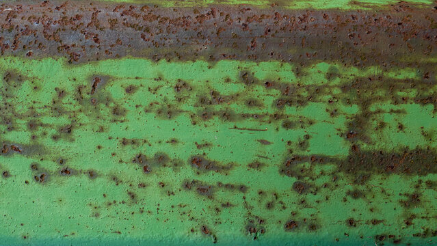 Very old green metal bar with rusty texture