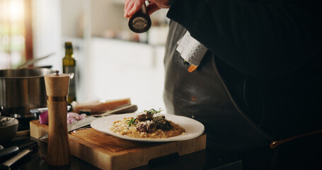 Spices, food and hands of chef with plate in kitchen of home for diet, private service or cooking. Ingredients, recipe and closeup of person seasoning dish for gourmet cuisine, meal flavor or lunch