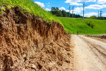 Cut soil layer on a slope near a country road