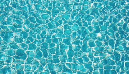 Azure pool water, rippled and sun-drenched.  Light reflects on the surface, creating a mosaic-like effect