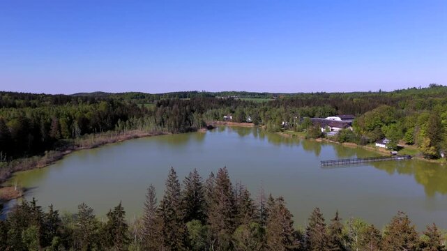 Aerial view of Esssee, a shrinking glacial lake near the Max Planck Institute for Biological Intelligence, in Seewiesen, Gemeinde Poecking, Landkreis Starnberg, Upper Bavaria, Germany in spring