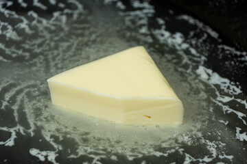 Butter is melted in a pan, the process of frying in butter.