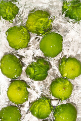 Vibrant Limes Submerged in Water Surface Scene