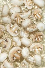 Raw White Mushrooms Champignons Close-Up Splash in a Water Top View