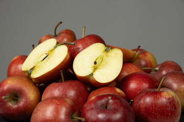 Group of fresh red whole apples and apple halves close-up.