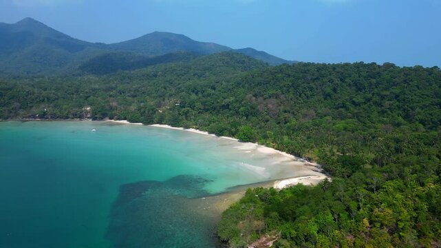 ong beach at koh chang island showing turquoise water and green rainforest in Trat Province, Thailand. Dramatic aerial view flight speed ramp hyper motion time lapse