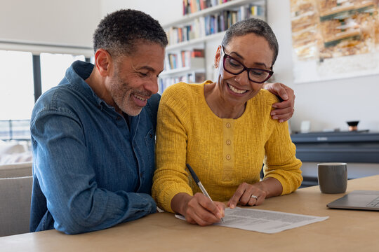 Couple joyfully signing a contract together