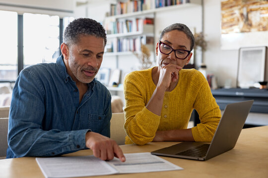 Couple discussing documents with focused intent