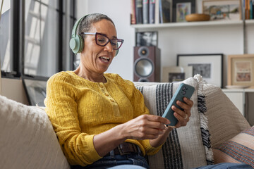 Mature woman learning a new language using a smartphone