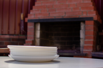The concept of relaxing with barbecue at the grill at home. Plates on the background of a stone grill