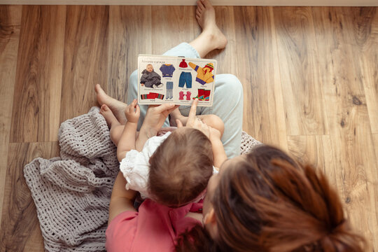 mother and baby reading a book, top view, speech and vocabulary development