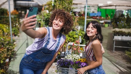 Fototapeta premium Garden center workers taking a selfie with flowers