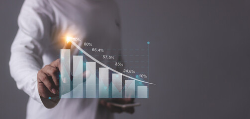 Young man with smartphone hand touching to visualize money growth The phone screen displays graphs...