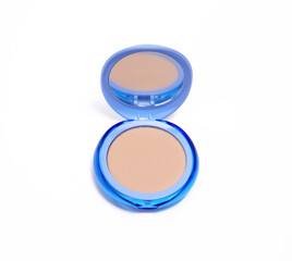 Blue compact powder case with a mirror, featuring a smooth, light beige powder inside.