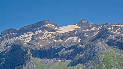 Granite alpine mountain top with glacier on a sunny day with clear blue sky in La Vanoise national park, franc