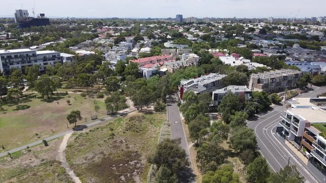 Aerial drone moves forward over leafy Kensington suburb on a sunny day