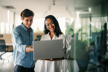 Busy smiling executive business team using digital devices in office. Diverse professional people