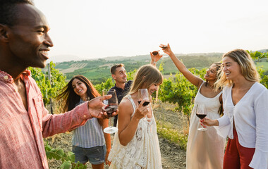Multiracial friends dancing at summer party inside vineyards - Happy people having fun together...