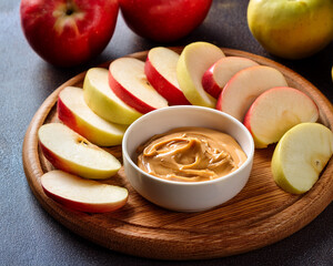 Apple Slices on a Wooden Board with Peanut Butter Dip