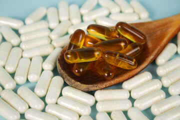 Vitamin capsules on a blue background. Food supplements, dietary supplements
