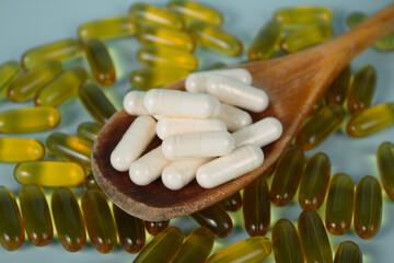 Vitamin capsules on a blue background. Food supplements, dietary supplements