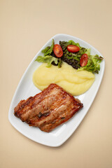Braised ribs with potato puree and salad
