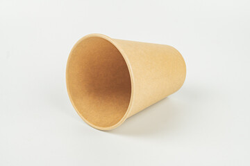 Image of a sealed disposable coffee cup with lid on neutral background, implying on-the-go convenience and environmental friendliness for marketing