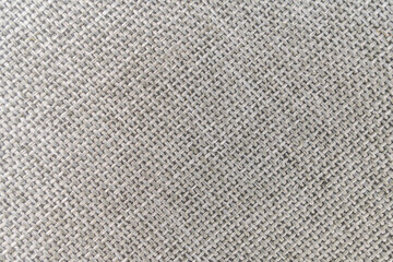 Close-up view of textured neutral fabric surface, possibly part of a garment or textile product
