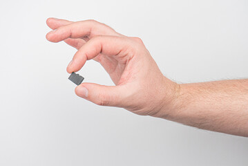 Close up SD memory card in fingers