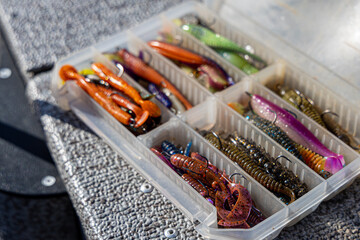 Fishing tackles and fishing baits in box .Classic Colored Fishing Lure , Beautiful Background...