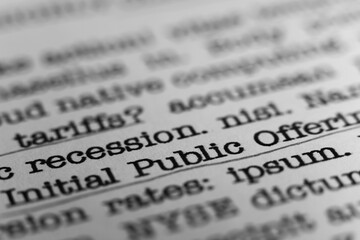 Initial Public Offering. Text printed on a page. A piece of paper with a phrase written in retro...