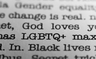 Obraz premium LGBTQ plus. Text printed on a page. A piece of paper with a phrase written in retro typewriter font