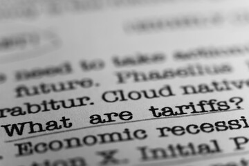 What are tariffs. Text printed on a page. A piece of paper with a phrase written in retro...