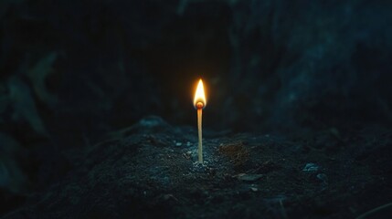 Fototapeta premium A matchstick igniting with a small but bright flame in a dark room, illuminating the surrounding space briefly