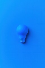 Minimalist Blue Lightbulb on Blue Background Flat Lay Top Down Idea Concept Innovation Creativity Energy