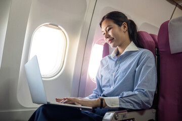 Business travel productivity with passenger working on a laptop onboard