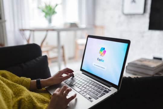 Woman working remotely using copilot ai software on laptop