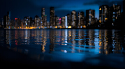 Fototapeta premium Urban skyline with towering skyscrapers lit up at night, reflecting the city’s vibrant energy.