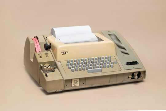 Pavia, Lombardy, Italy - March 13, 2025: Teletype Model 33 teleprinter, introduced in 1963. It was the first computer terminal used by Bill Gates. Shown at MUSDI Museum.