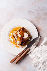 French toast with caramelized banana, syrup and almonds.
