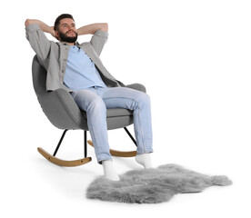 Handsome man relaxing in rocking chair and furry rug on white background