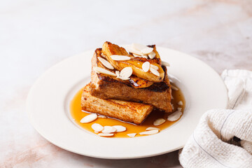 French toast with caramelized banana, syrup and almonds.