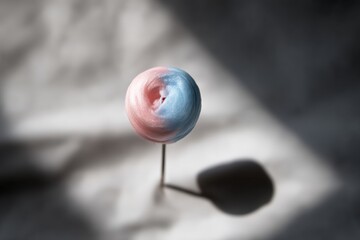 Colorful cotton candy on a stick beautifully displayed against a soft background in natural light