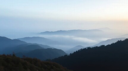 Obraz premium Serene Foggy Mountain Landscape at Dusk with Soft Blue Tones