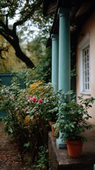 Cozy porch with teal columns and potted flowers creates a tranquil exterior garden atmosphere outdoors on overcast day garden architecture