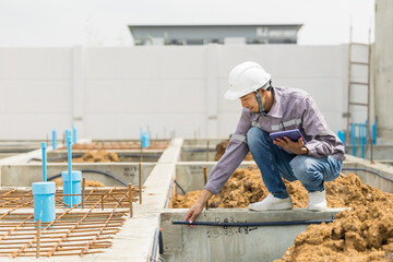 Asian construction engineer, Japanese builder worker male working inspecting footing house building.
